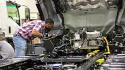 An upfitter examines wire placement on an Isuzu NRR EV chassis at the NTEA Commercial Vehicle Upfitter Summit in Sandusky, Ohio. An upfitter examines wire placement on an Isuzu NRR EV chassis at the NTEA Commercial Vehicle Upfitter Summit in Sandusky, Ohio.
