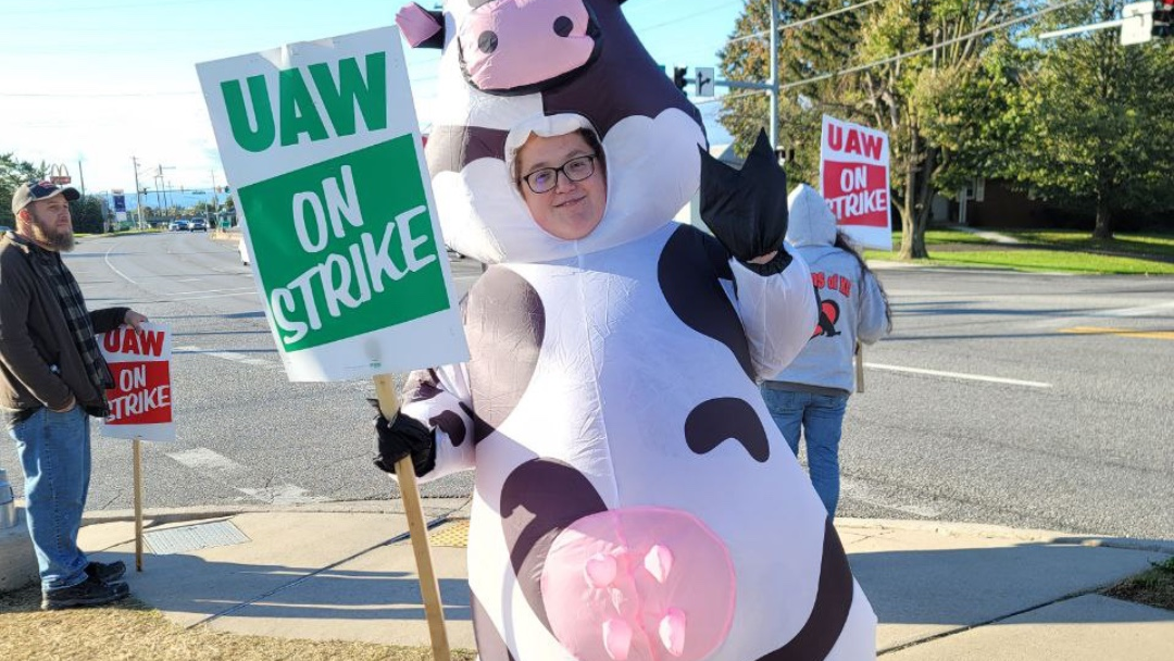 A picketer milking the moment outside Mack's facilities in Hagerstown, Maryland.