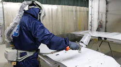 Fleet Fast's Francisco Esquivel dons his painting suit to apply a clear coat.