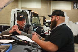 A Rush technician speaks with his judge while at the Medium-Duty: Ford Division. A Rush technician speaks with his judge while at the Medium-Duty: Ford Division.