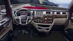 Cab mockup shows 589’s digital instrument cluster (left, ahead of the wheel), including the combination speedometer and tachometer. Electro-mechanical gauges on center panel show engine and drive axle temperatures and pressures. Woodgrain and brushed metal highlight the upscale trim in this cab; the test daycab had plainer but still pleasant interior panels. Cab mockup shows 589’s digital instrument cluster (left, ahead of the wheel), including the combination speedometer and tachometer. Electro-mechanical gauges on center panel show engine and drive axle temperatures and pressures. Woodgrain and brushed metal highlight the upscale trim in this cab; the test daycab had plainer but still pleasant interior panels.