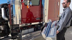 Wide cab looks inviting, and three grab handles—two inside and one on the exhaust stack—make for a safe and easy climb into it. Doors are triple sealed for quietness and interior cleanliness. Jacob White, product marketing director who helped design the 589, holds the cover for the battery box that includes a small tool compartment. Wide cab looks inviting, and three grab handles—two inside and one on the exhaust stack—make for a safe and easy climb into it. Doors are triple sealed for quietness and interior cleanliness. Jacob White, product marketing director who helped design the 589, holds the cover for the battery box that includes a small tool compartment.