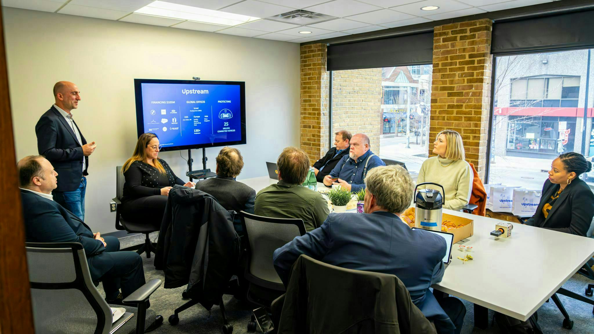 Yoav Levy, Upstream's cofounder and CEO, addressing a group of automotive journalists and Justine Johnson (far right), Michigan&rsquo;s chief mobility officer, at the company's U.S. headquarters in Ann Arbor.