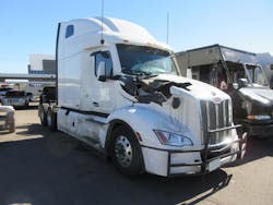 This Peterbilt Model 579 was severely damaged by a dual trailer wheel that came off a passing tractor-trailer. This Peterbilt Model 579 was severely damaged by a dual trailer wheel that came off a passing tractor-trailer.