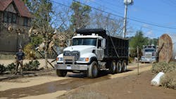 Mack and Peterbilt trucks help remove dirt and debris leftover from floodwaters at the intersection of Brook and Reed Streets in Asheville, NC. Mack and Peterbilt trucks help remove dirt and debris leftover from floodwaters at the intersection of Brook and Reed Streets in Asheville, NC.