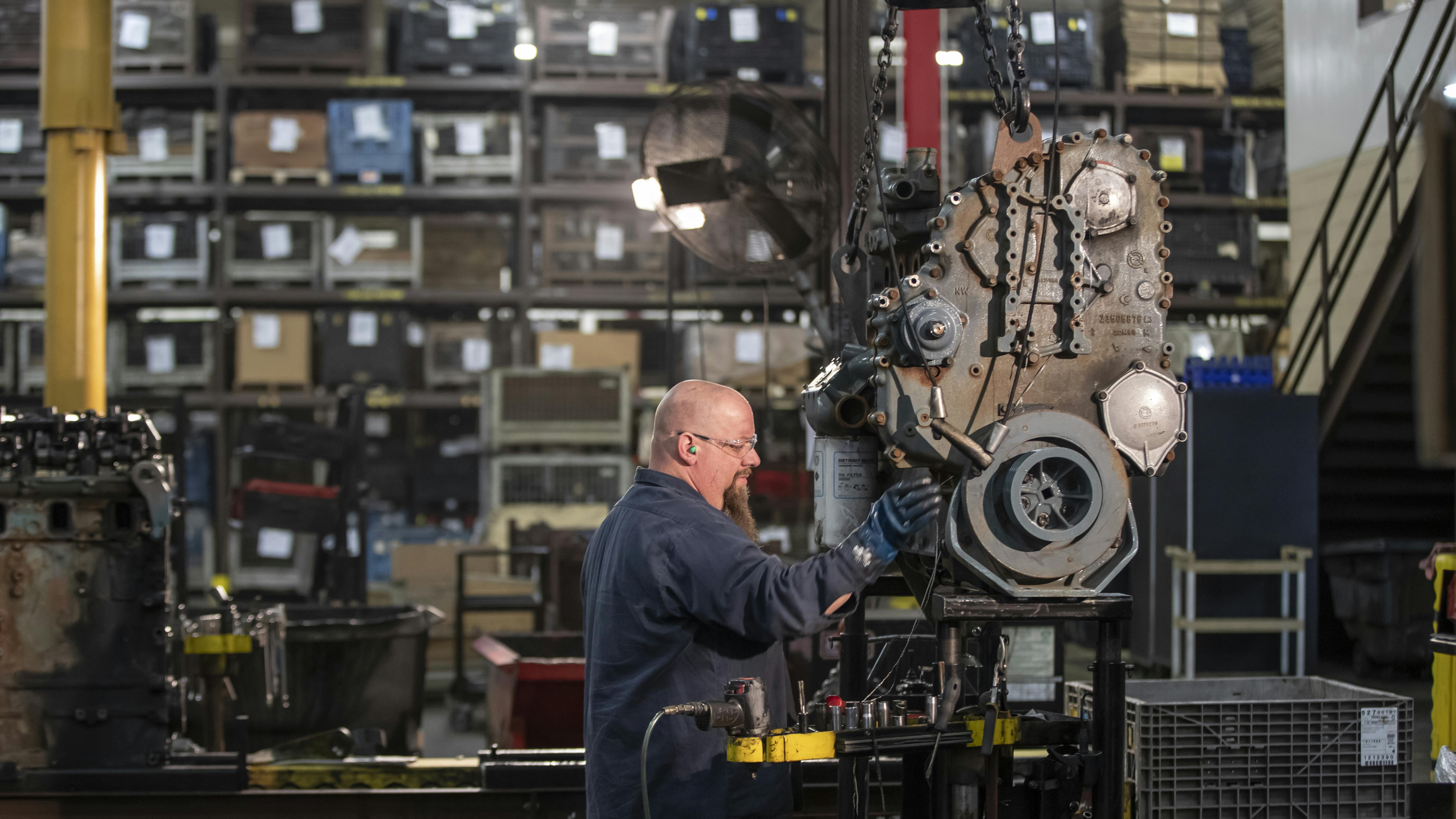 As an alternative to an in-frame overhaul, swinging a reman engine is another option for fleets looking to extend the life of a vehicle. Remanufactured engines are factory-assembled and tested by the OE. Pictured is a technician in a Detroit reman center.