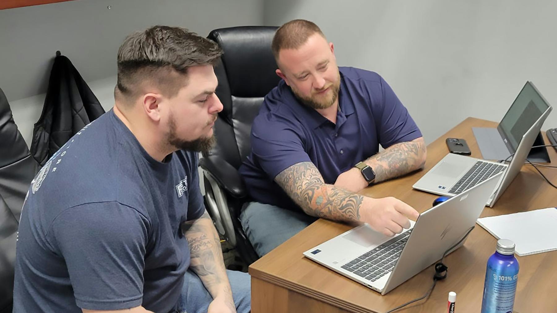 Matt Brown, regional maintenance manager, at right, goes over a review with Justin Coon, at left.