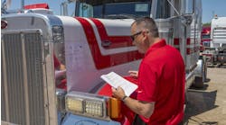 Auctioneer inspects truck Auctioneer inspects truck