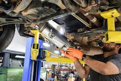 A Bullet Proof Diesel technician installs a new DPF on a truck. A Bullet Proof Diesel technician installs a new DPF on a truck.