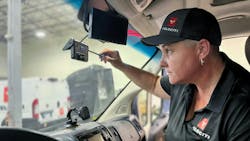 A Velociti technician performs maintenance on a customer dashcam. A Velociti technician performs maintenance on a customer dashcam.