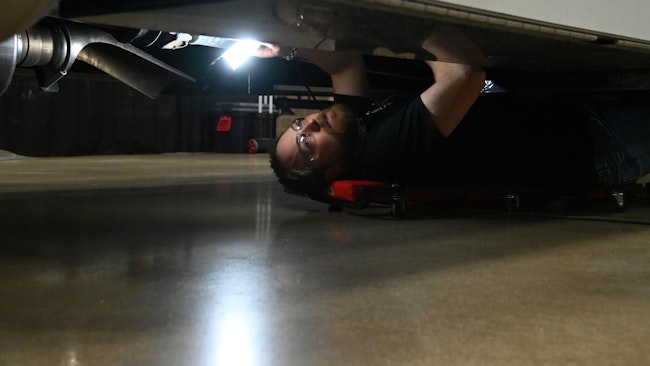 Technician under truck Rush rodeo top maintenance concerns