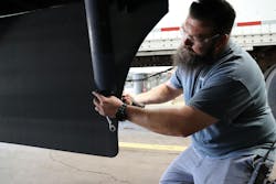 Technician works on a trailer fairing Technician works on a trailer fairing