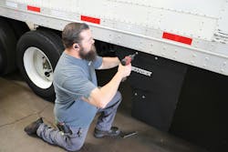 Tech works on trailer skirt Tech works on trailer skirt