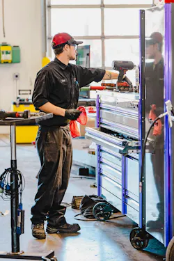 Technician uses tools at work station Technician uses tools at work station