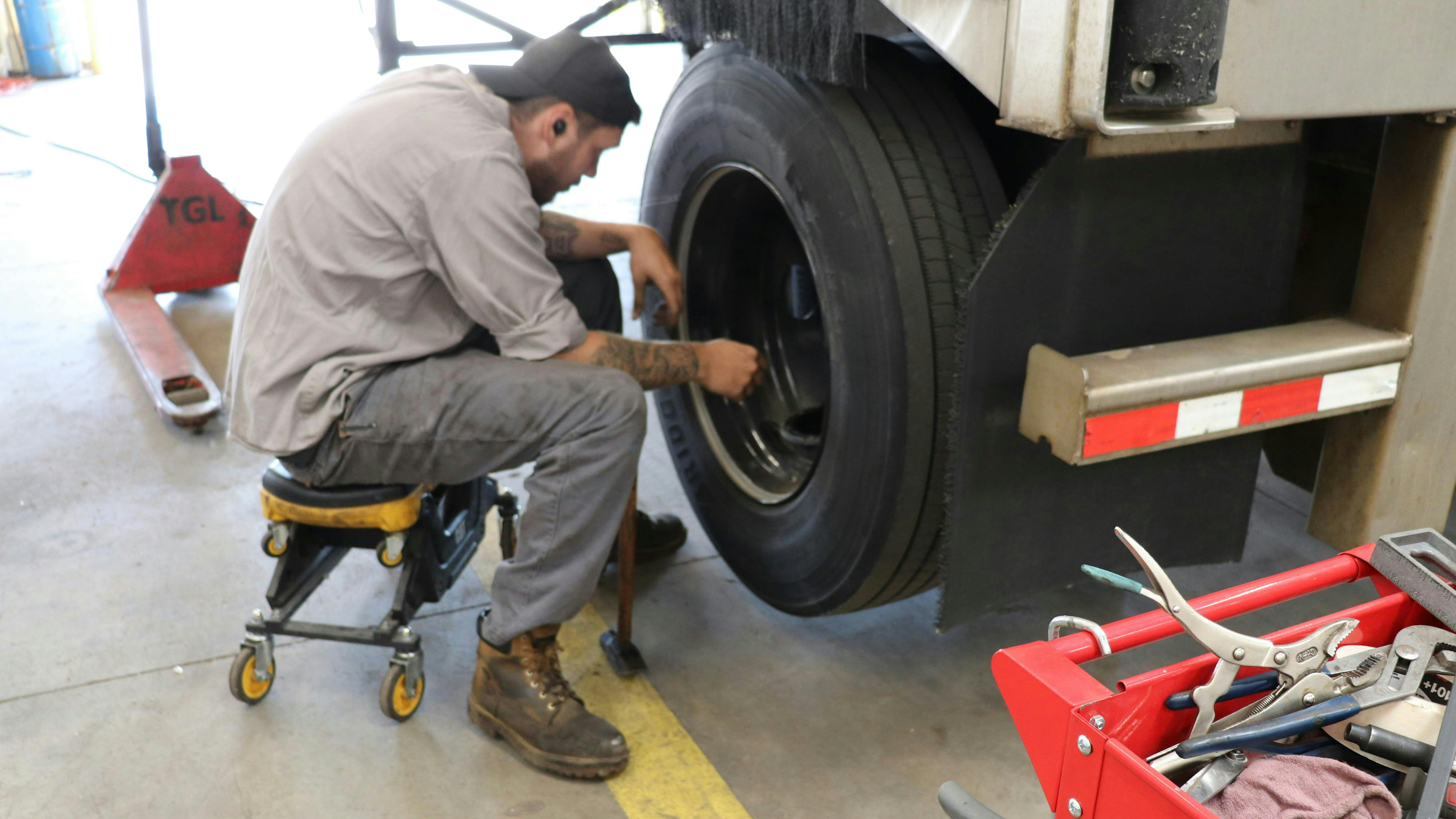 tech inspecting wheel end