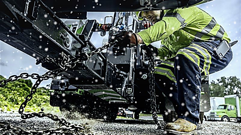 Technician works on a vehicle during the winter