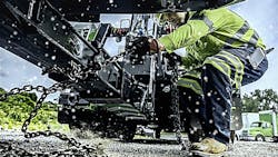 Technician works on a vehicle during the winter Technician works on a vehicle during the winter