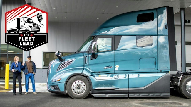 Service advisor posing with driver at truck