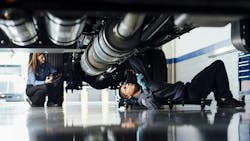 Penske tech inspecting under chassis Penske tech inspecting under chassis