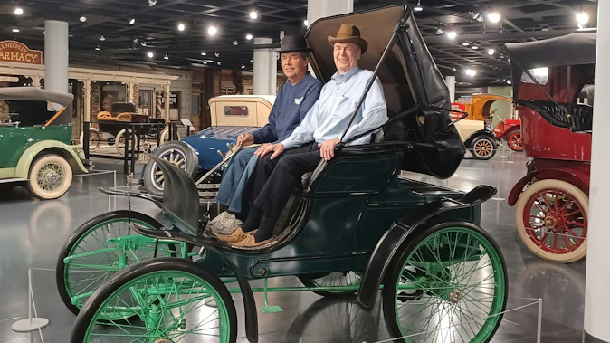 Tony Allison (L) and Jim Winton (R), the great-grandsons of the men involved in the historic first Winton transaction, sit in a Winton Phaeton.