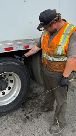Jesse Petersen, a lead technician with Bergey’s Commercial Tire Centers, uses the Haltec digital tread depth tool to quickly assess tire health on a tractor-trailer.