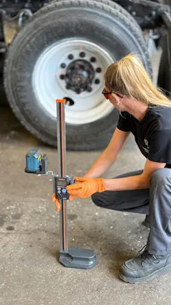 Missy Albin uses International Motors project manager David Bialas’ ride height tool to get measurements without crawling under the vehicle.